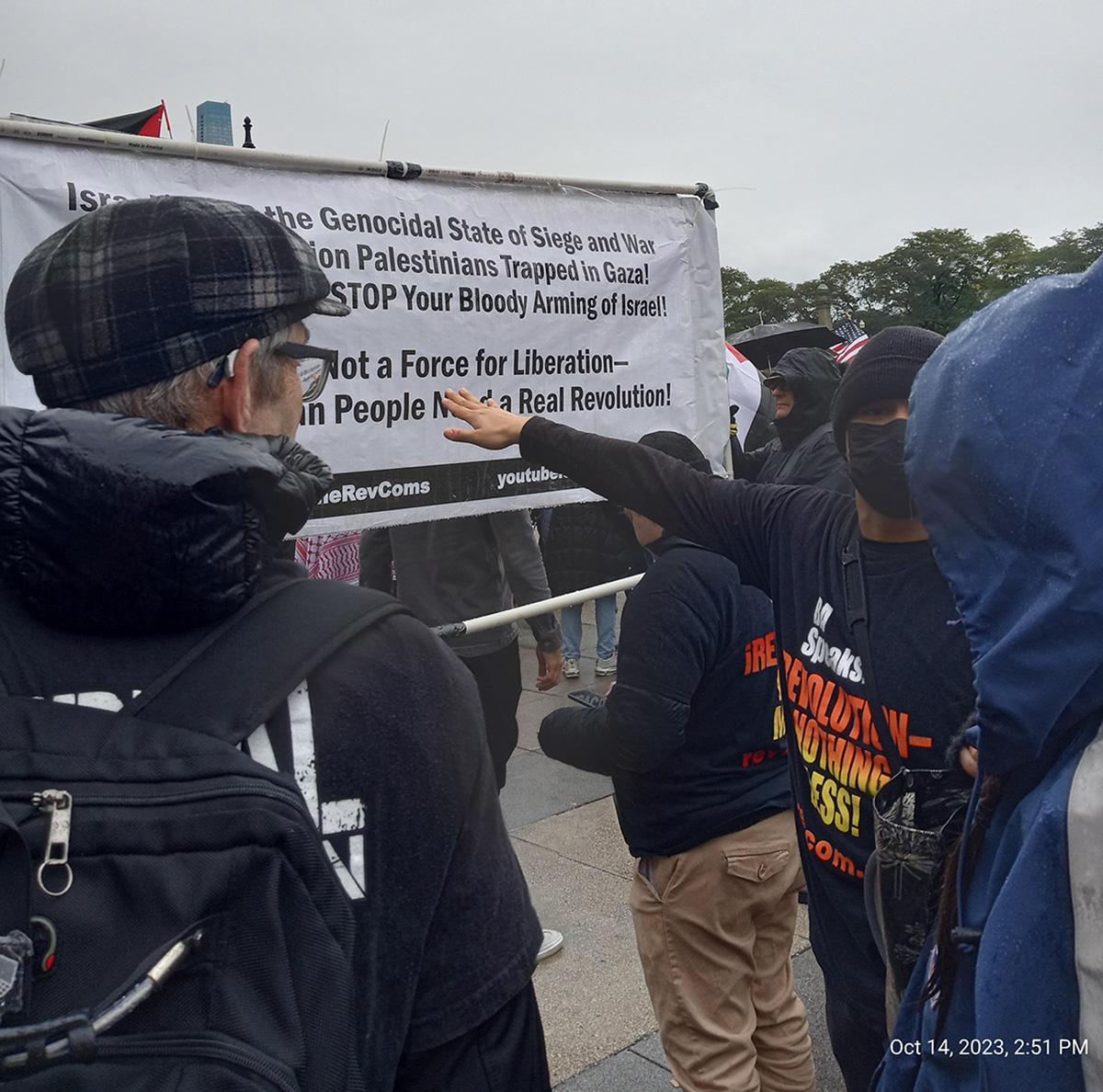 Chicago RevCom points to banner with slogans