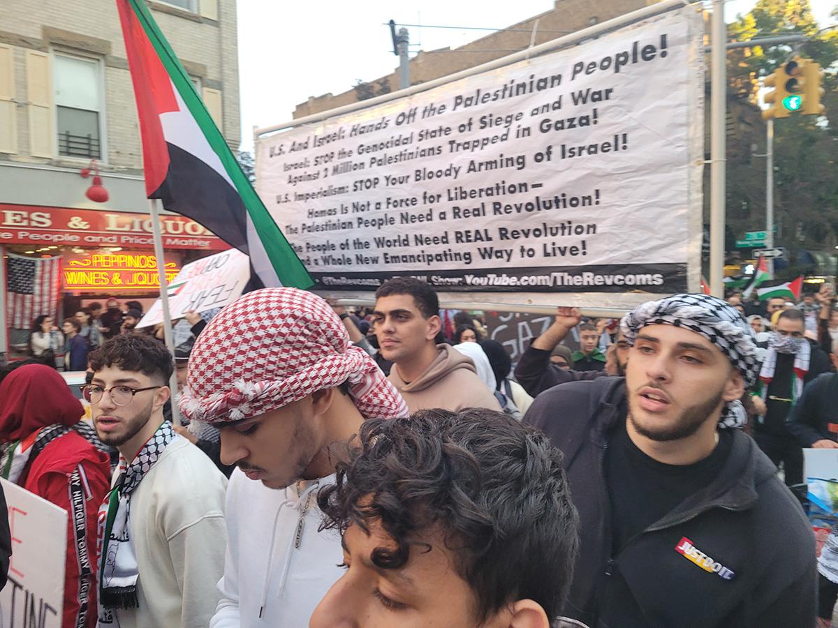 Revcoms with other protesters carry the banner in the Bay Ridge section of Brooklyn, NY, October 21, 2023.