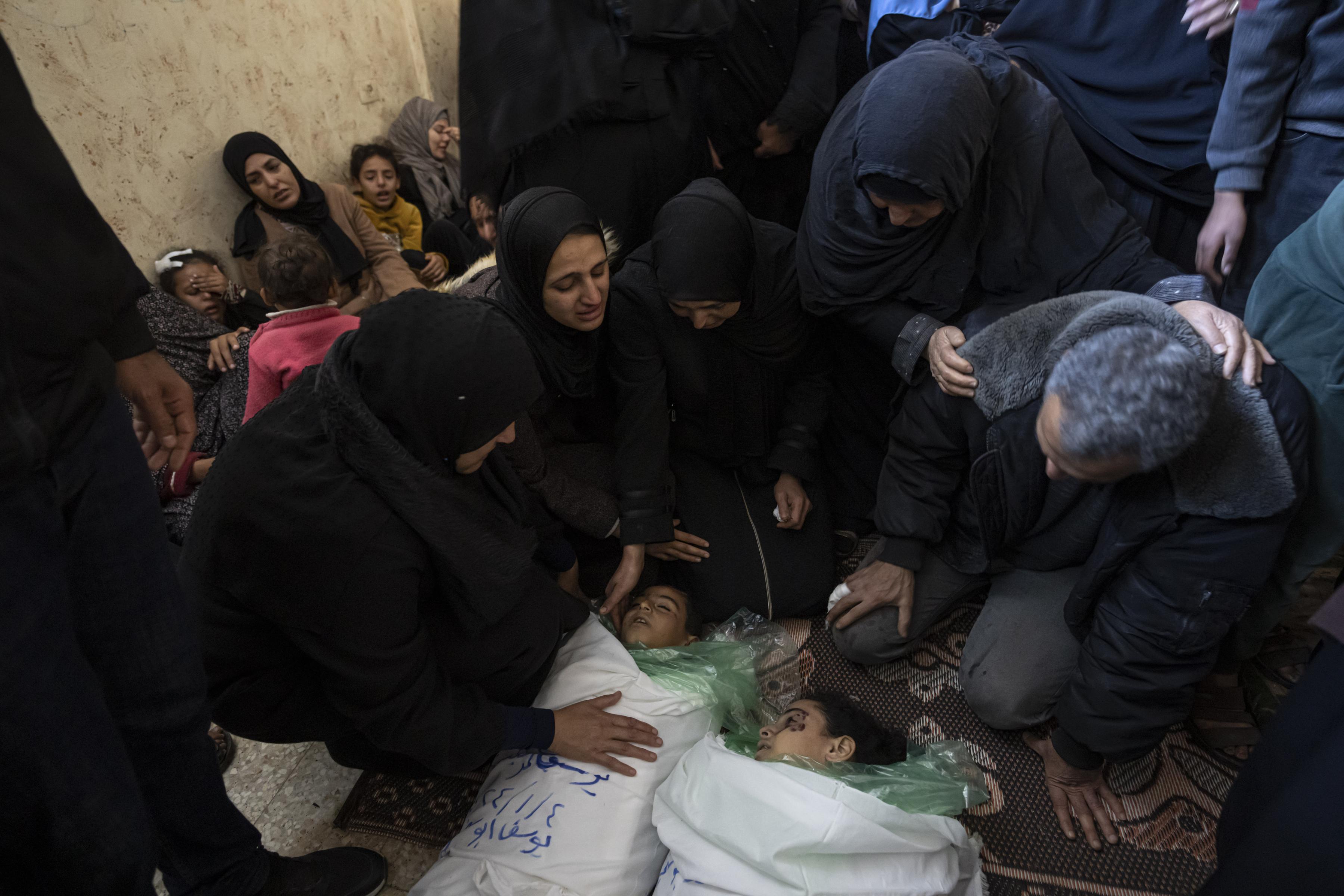 A family mourns the deaths of children at the hands of Israeli bombs