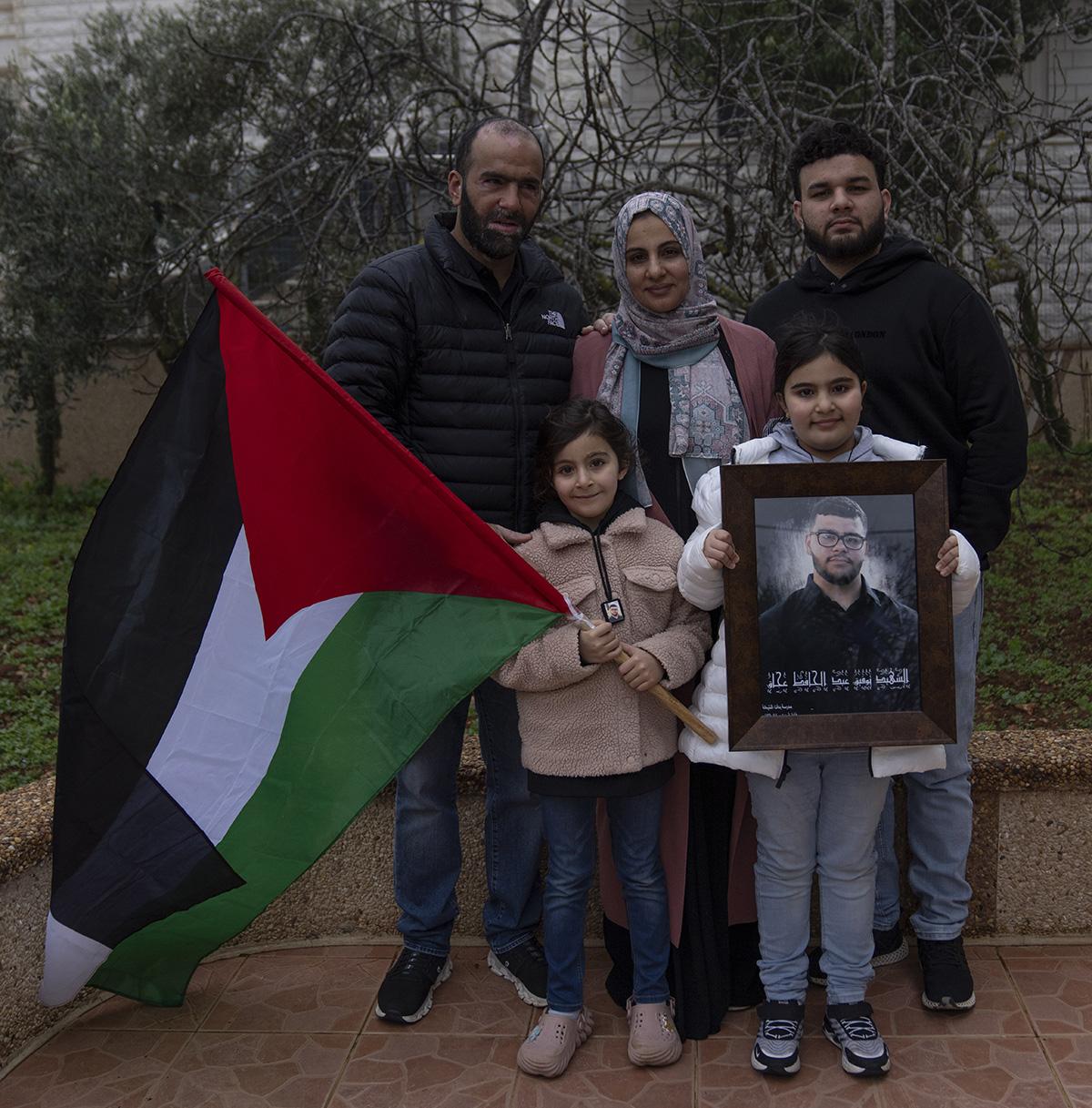 Family with portrait of slain 17-year-old Tawfic Abdel Jabbar, January 23, 2024.