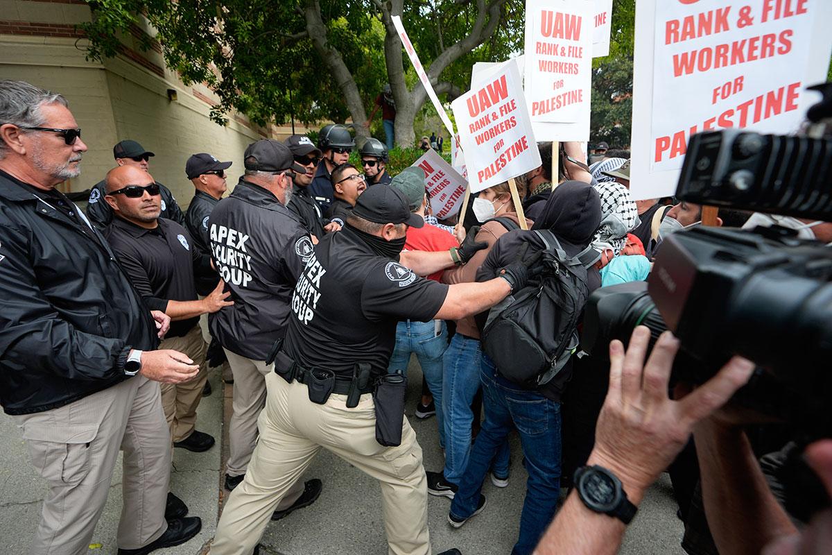 University security officers push students protesting for Palestine at UCLA in Los Angeles, May 23, 2024. 