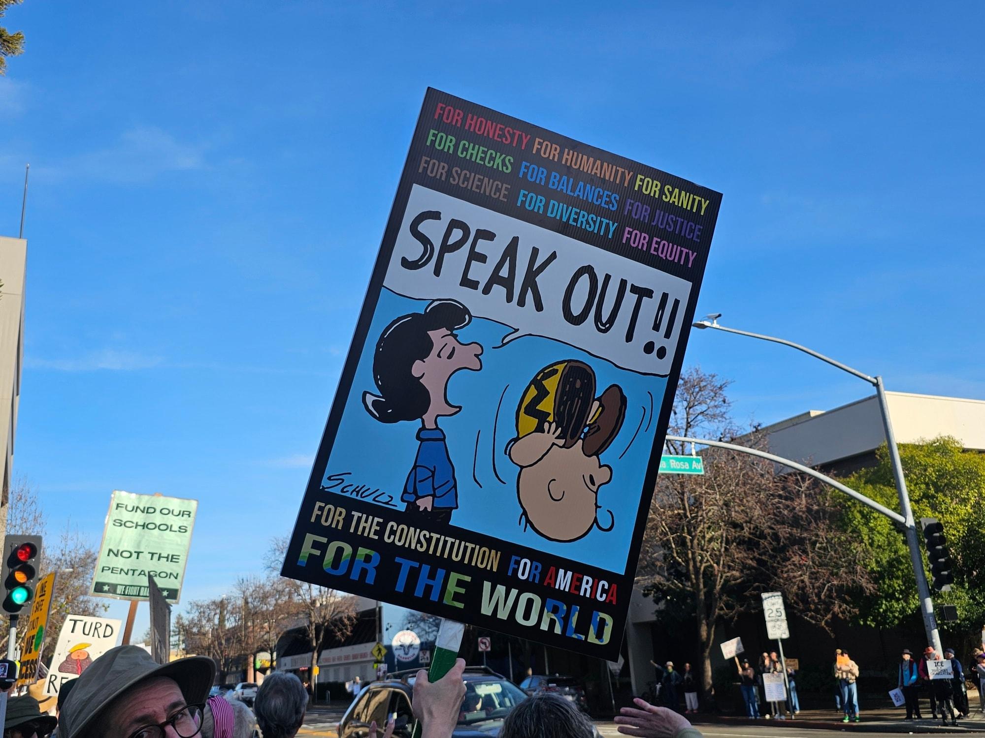 Sign in Santa Rosa, California: Charlie Brown cartoon with Lucy yelling Speak Out!! 