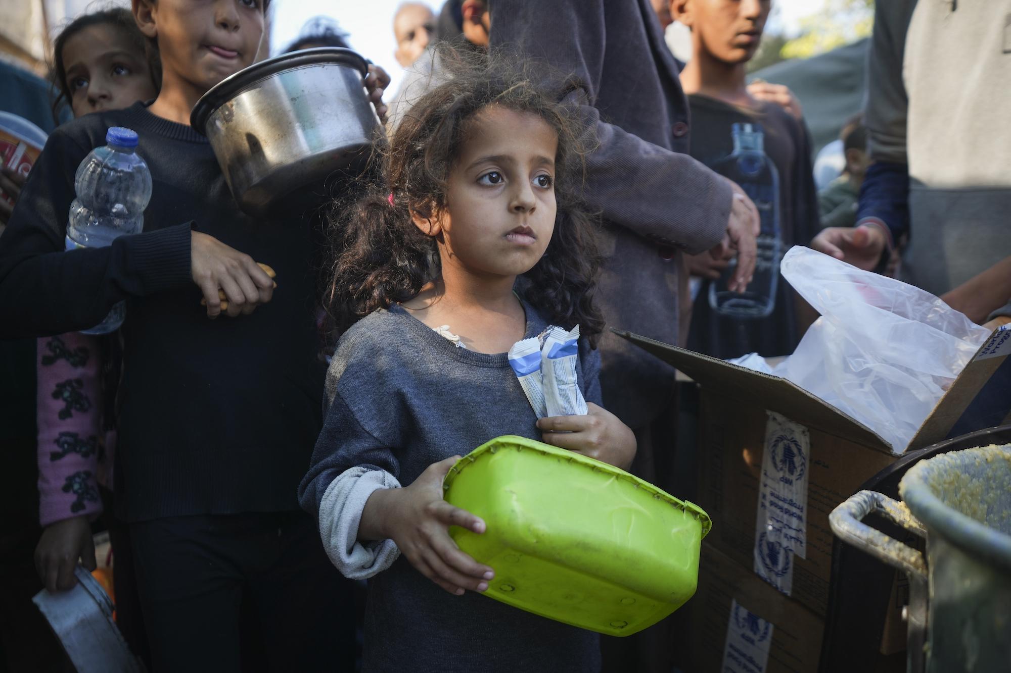 Young girl stands in food line in Gaza, November 18, 2024.