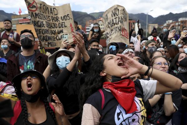 Women shout slogans on May Day protest, Bogota Colombia