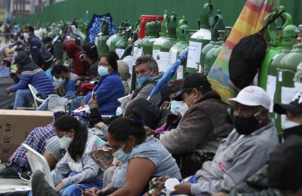 People wait for oxygen refill in holding stadium, Lima, Peru