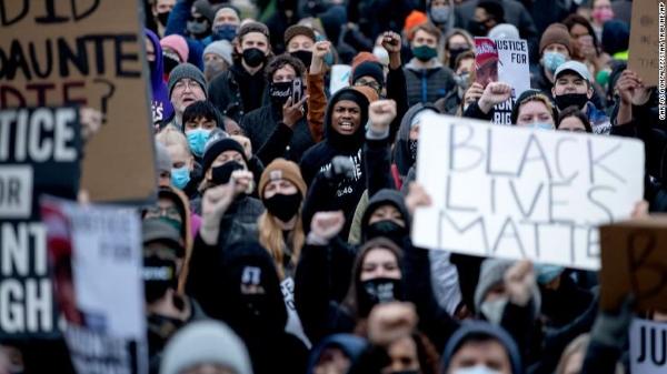 Protesters, Black Lives Matter and Daunte Wright signs at Brooklyn Center