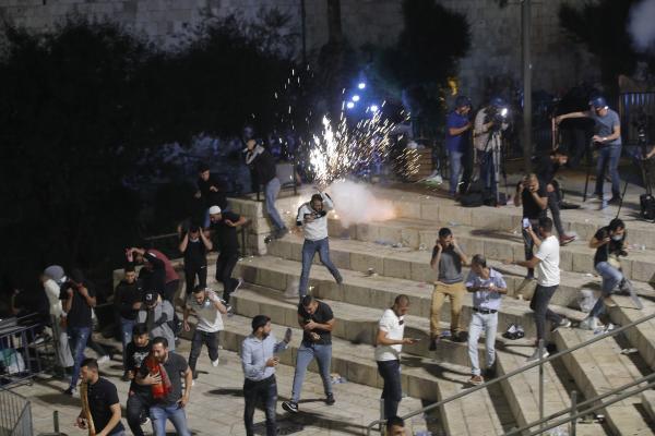Night scene, Palestinians reacting to Israeli stungun firings.