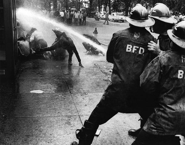 Fire department turns hoses on civil rights protesters in Birmingham.
