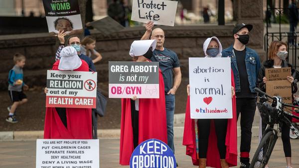 Pro abortionists dressed as handmaids protest in Austin, Texas.