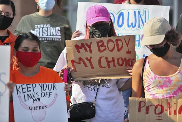 Pro abortion protesters with signs in Austin, Texas.