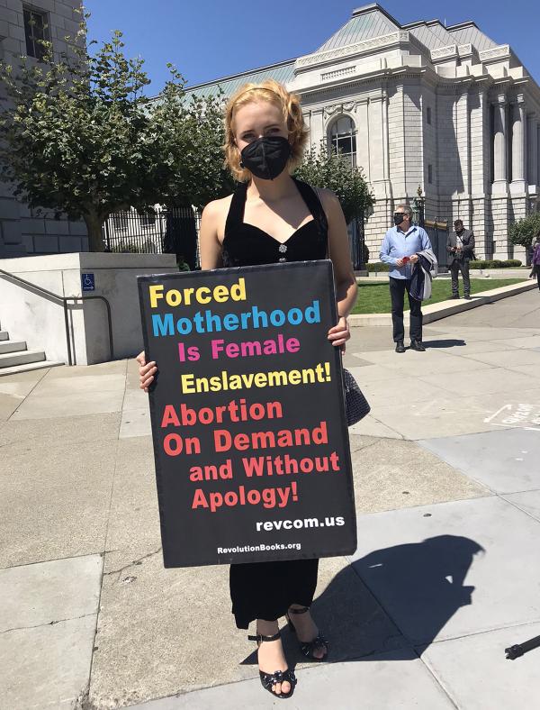 Woman with Abortion on Demand without Apology sign.