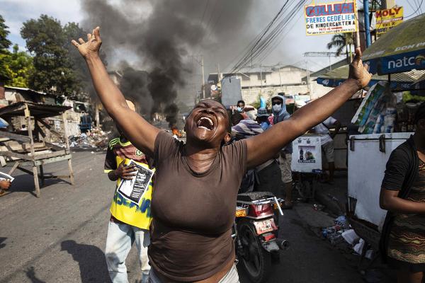 Haitian woman yells against the horror of kidnapping by gangs.