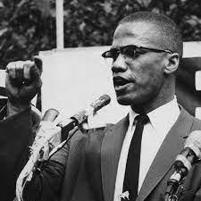 Malcolm X speaking, gesturing