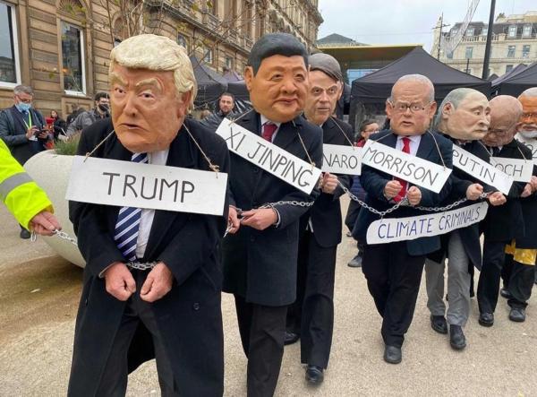 Climate Criminals - Protesters in chains with masks of Trump, Xi Jinping and other world leaders 
