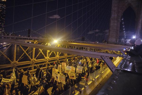 Protesters against verdict of Kyle Rittenhouse march across Brooklyn Bridge, New York.