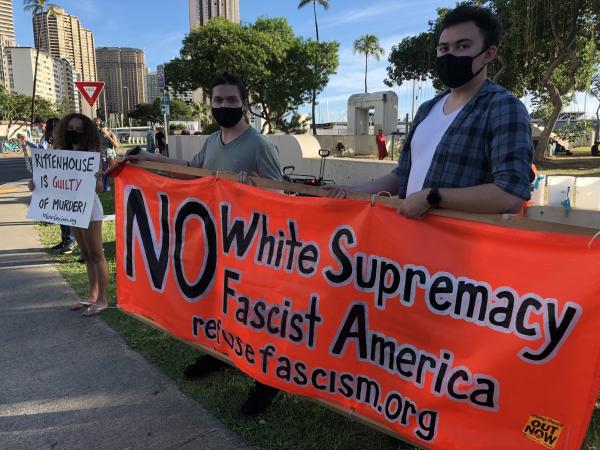 In Honolulu large red banner with slogan NO White Supremacy Fascist America protesting Rittenhouse verdict.