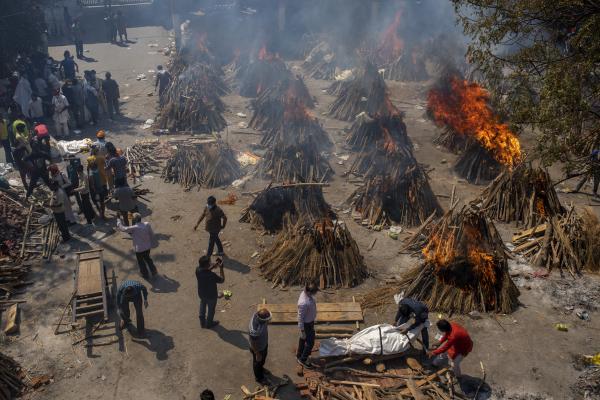Multiple funeral pyres in New Delhi, India cremate bodies of people who died of Covid 19.
