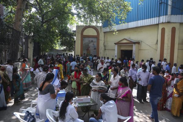 People in India line up to register to receive Covid 19 vaccine.