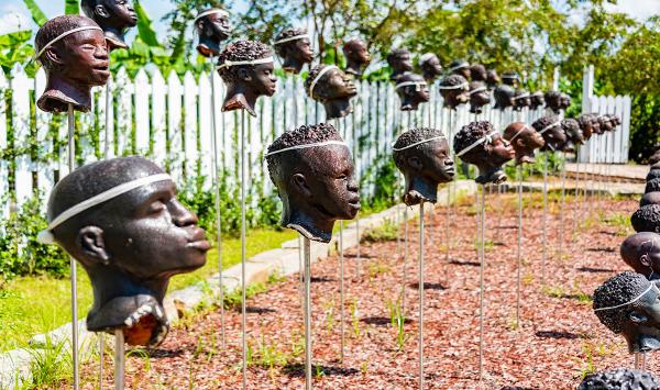 Monument to 1811 slave rebellion, sculptured heads murdered enslaved people.