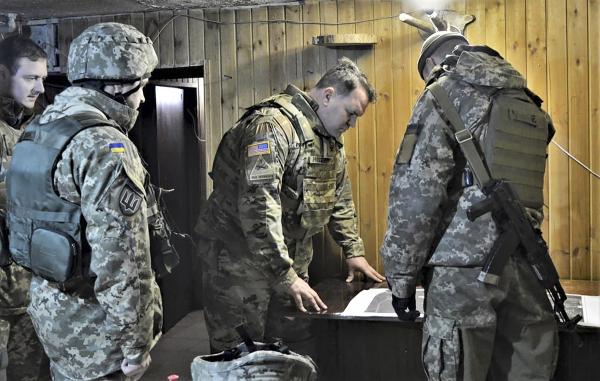 U.S. embassy delegation led by Army military attaché reviews map with Ukrainian officers who are conducting military operations against pro-Russian forces in eastern Ukraine.