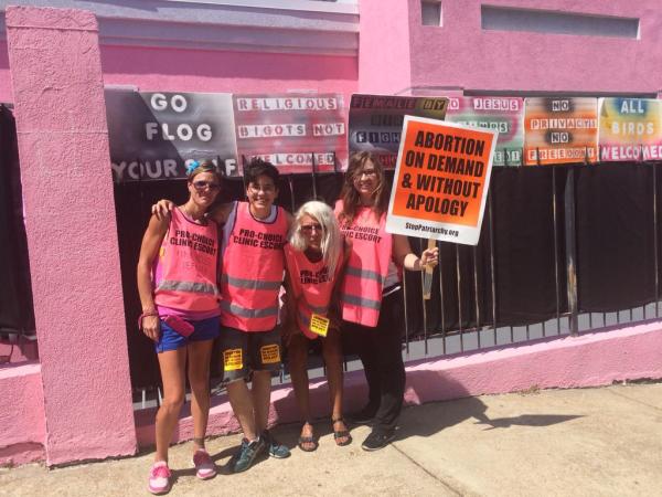 Abortion escorts in front of the "pink house," the last abortion clinic in Mississippi.