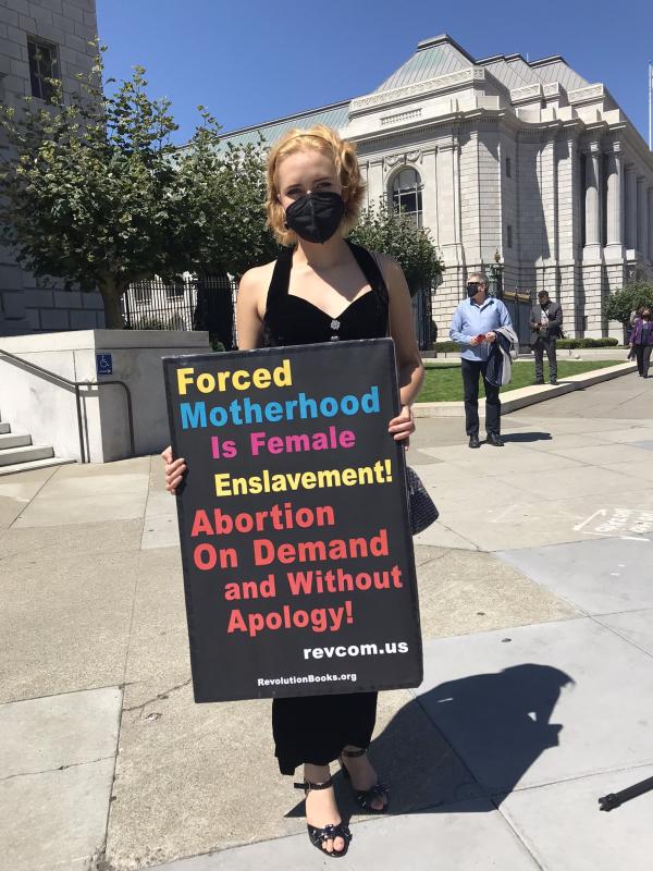 Woman with sign Forced Motherhood Is Female Enslavement.