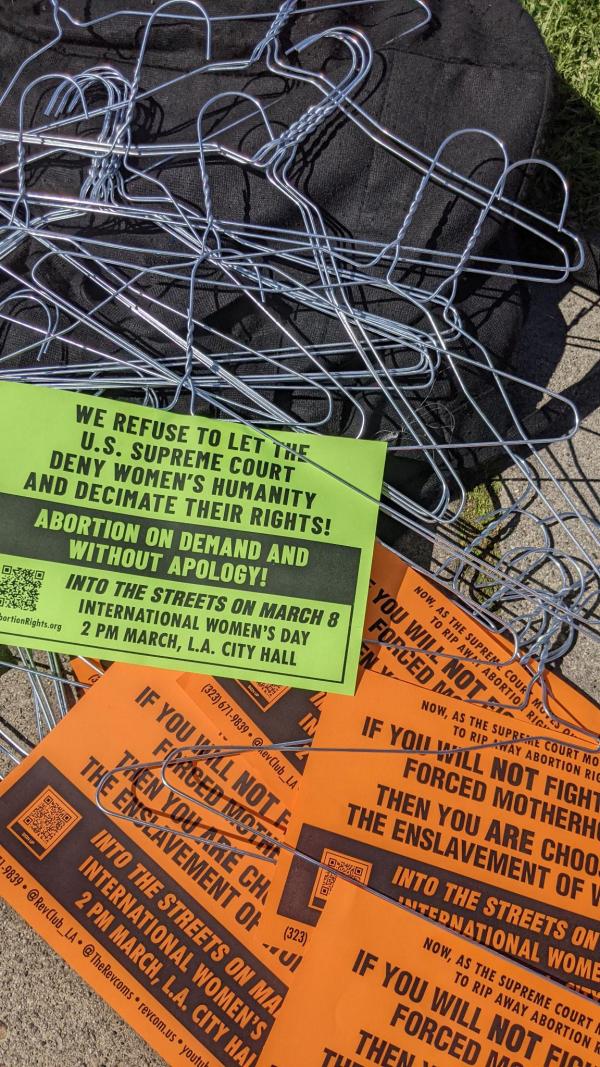 Stickers with Abortion on Demand and without apology, plus symbolic hangers.