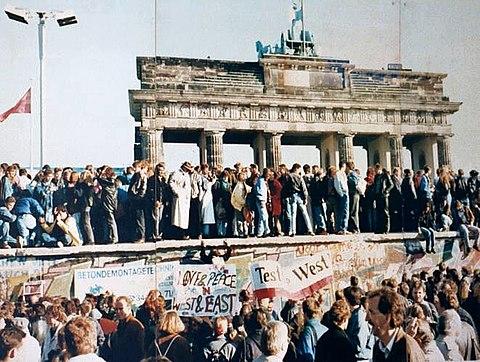 East and West Germans stand on the Berlin Wall days before it is torn down.