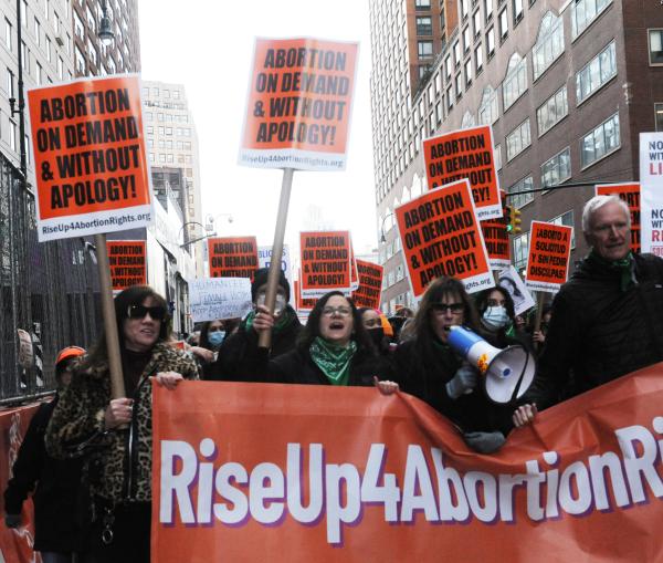 Banner for RiseUp4AbortionRights leads march on IWD in New York City.