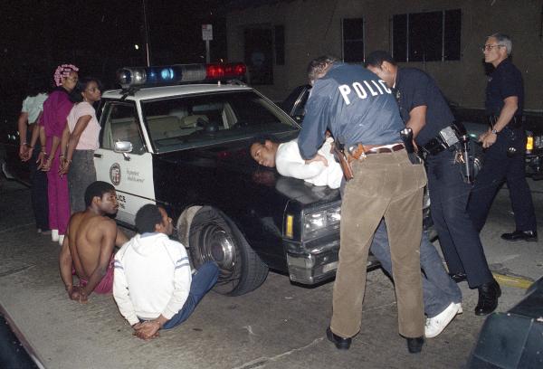 LAPD search youth in South Central as part of Operation Hammer, crackdown on gangs.