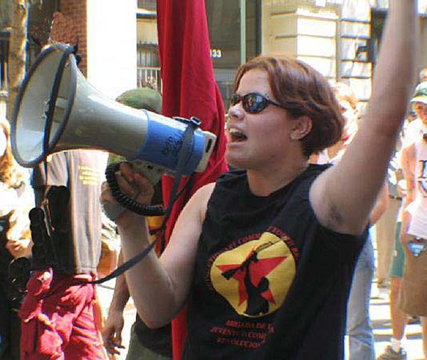 Member of Revolutionary Communist Youth Brigade with bullhorn.