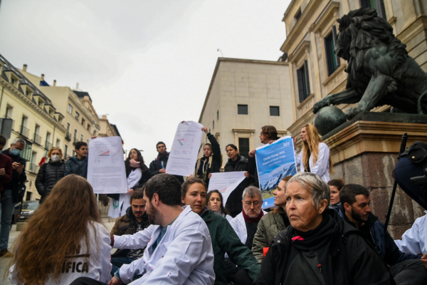 Scientist Rebellion activists in Madrid, Spain hold up IPCC climate report.