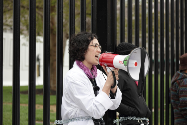 Scientist Rebellion activist chained to fence in front of White House, Washington, DC.