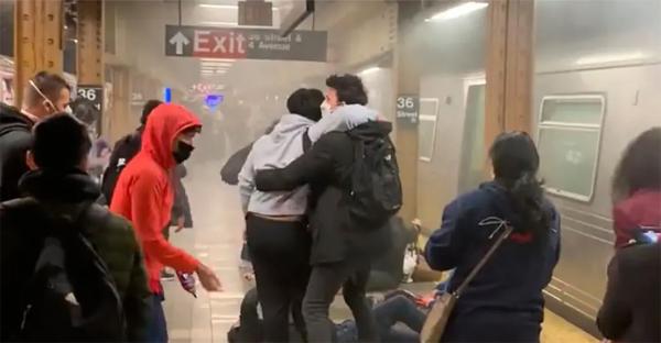 New York City Subway riders help each other out of smoked filled cars after shooting.