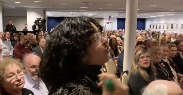 Protester in audience with green bandana