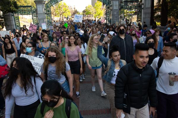 Berkeley students walk out and march through Sather Gate.