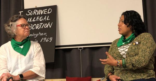 Angela, artist and art teacher, and Michelle Xai speak about abortion rights at Revolution Books.