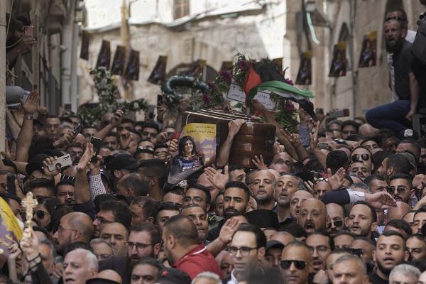 Palestinian mourners flood the streets carrying the coffin of Shireen Abu Akleh.
