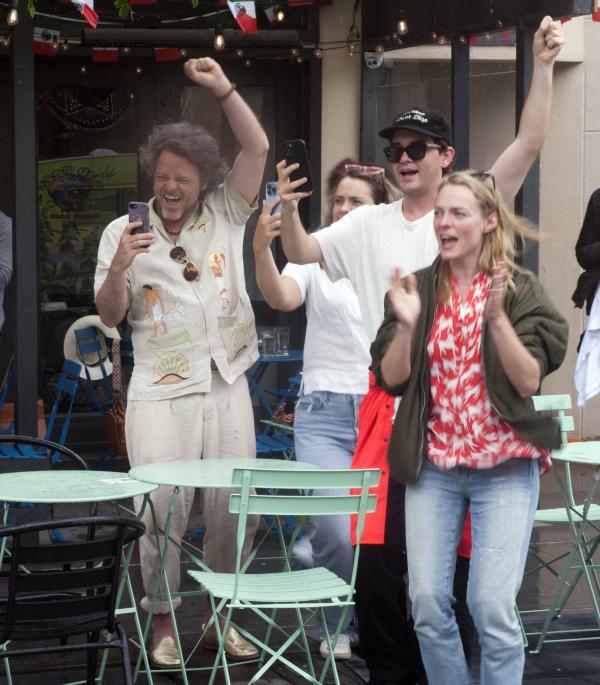 People in restaurants in NYC cheer for RU4AR march May 14