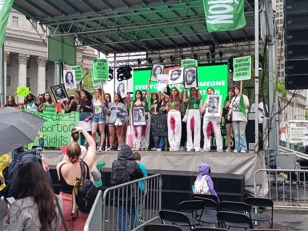 NYC RU4AR rally in Union Square speakers on stage, some with bloody pants