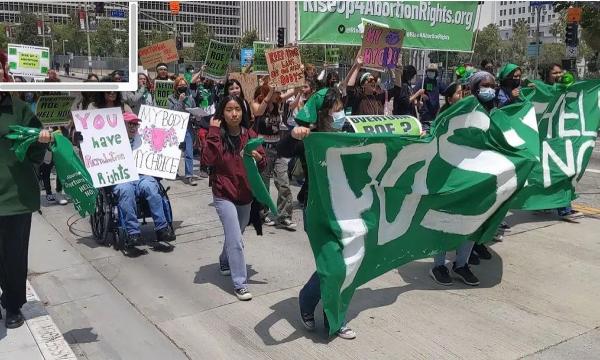 Los Angeles students walk out for abortion rights converge downtown with banner.