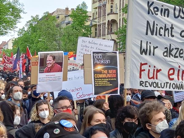 May Day 2022 Berlin, marchers hold placards featuring BA and New Communism