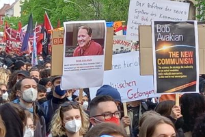 Marchers with posters of Bob Avakian and The New Communism