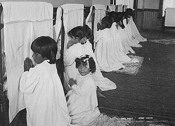 Arizona Native American girls forced to pray at their beds, c1900.
