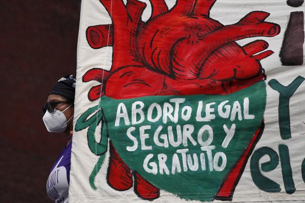 Mexican woman with sign: "Legal, Safe and Free Abortion."