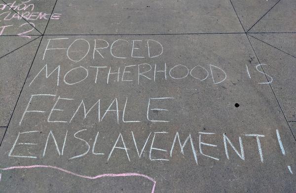 "Forced motherhood is female enslavement" chalked by RU4AR in front of Riverside Courthouse.