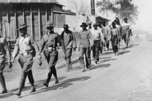 US Army troops marching Black farmers to prison