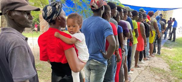 Haitians queue for hygiene kits against cholera.