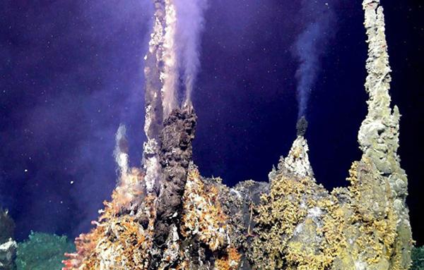Hydrothermal vent deep in ocean where light is unable to penetrate.