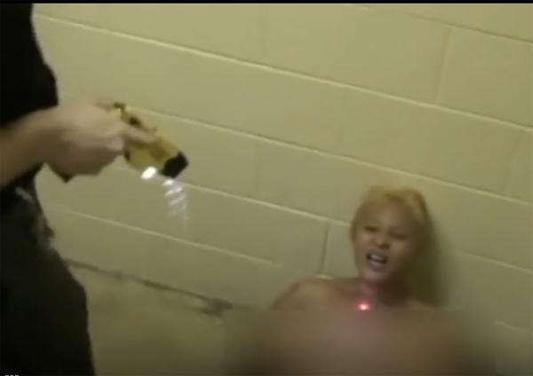 Screen grab of Martini Smith being tasered by guards causing her to miscarry.